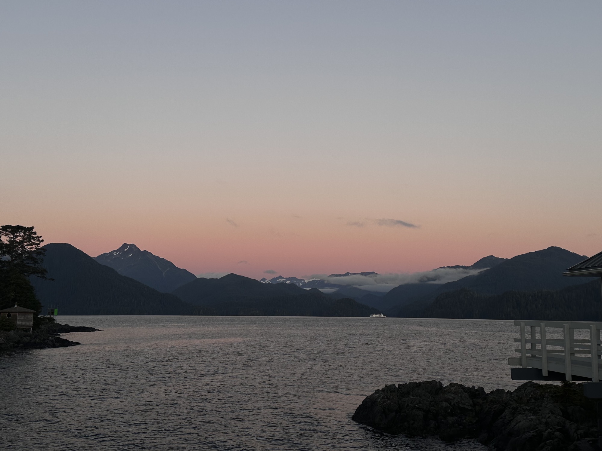 Pink sunset over a Sitka channel framed by mountain ridges